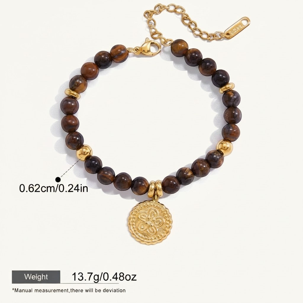 Seraphina Treasures Acantha bracelet with natural tiger eye stones and gold-tone accents, featuring a decorative coin charm.